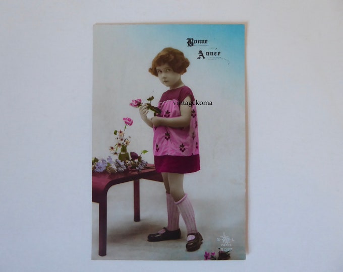 Happy New Year vintage postcard. Little girl 1930 with flower. Made in France. 1930. Vintage New Year.