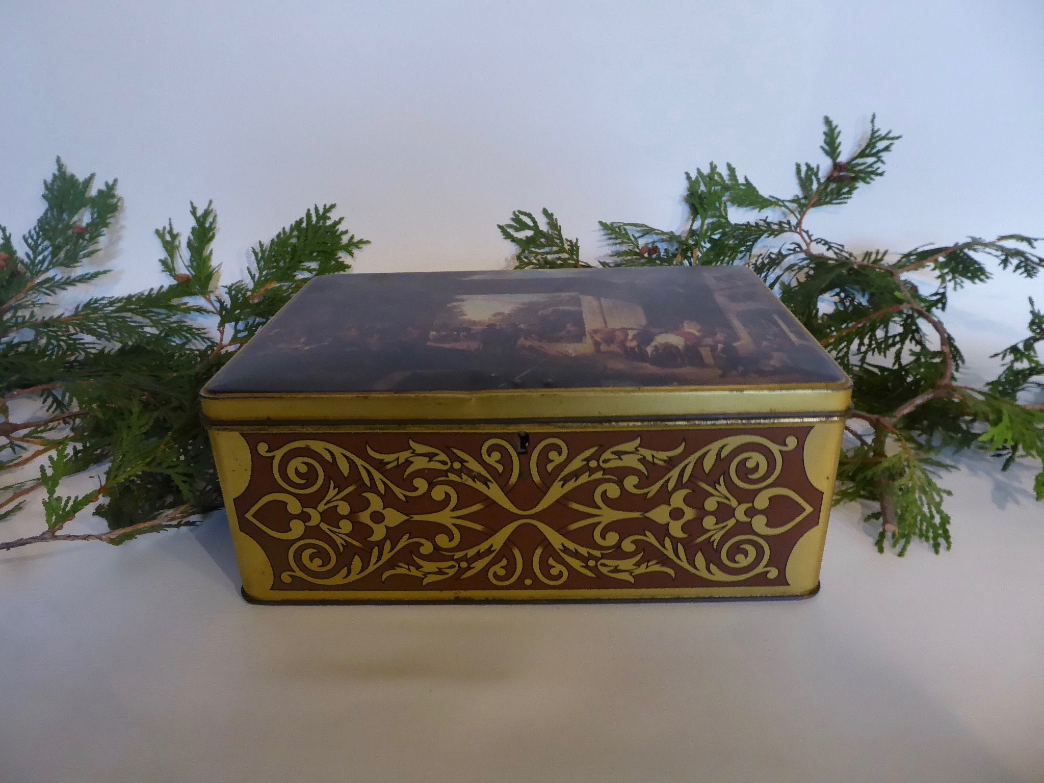 Large vintage metal box with lock. Scene farm inn 17th century. Golden