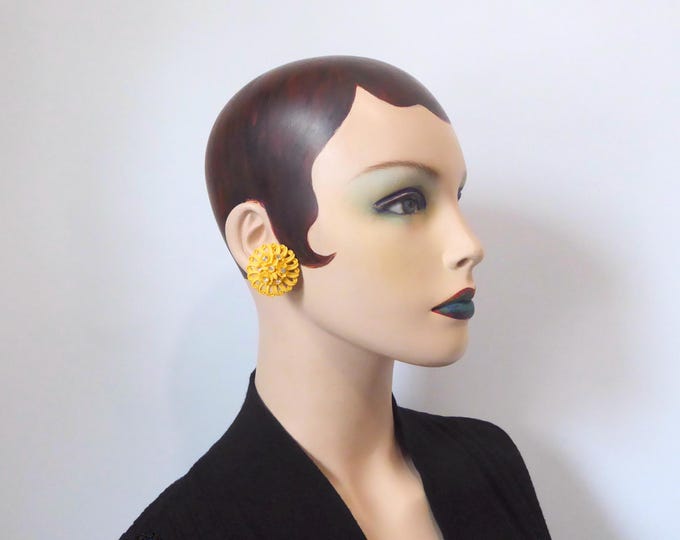 Clip-on earrings in yellow celluloid, sculpted with rhinestones. 1950s.