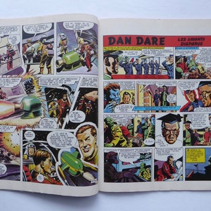 May include: A comic book page from the series "Dan Dare" featuring a colourful illustration of a rocket ship and a group of people in a futuristic setting. The text on the page reads "Dan Dare" and "Les Savants Disparus".