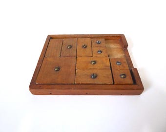 Vintage wooden sliding block puzzle. Handcrafted wooden game.