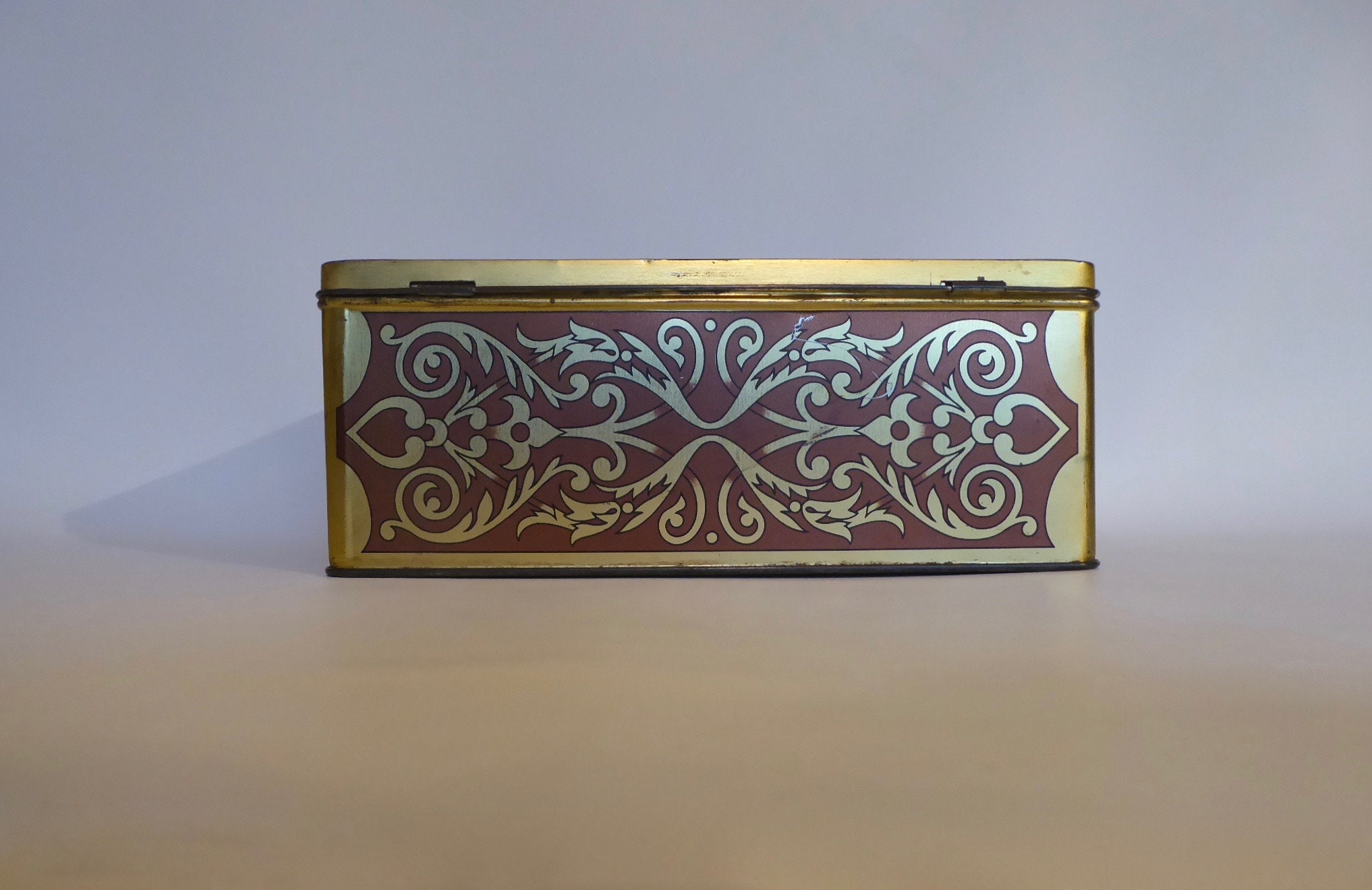 Large vintage metal box with lock. Scene farm inn 17th century. Golden geometric designs. Year