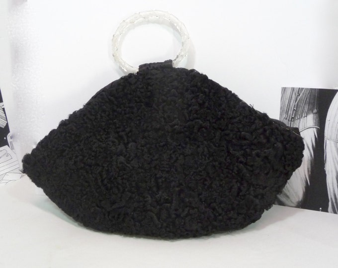 Black sleeve handbag. Astrakhan fur. Clear acrylic handle. 1940s.