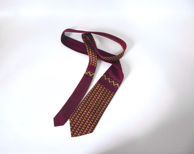 Jean-Paul Gaultier tie with a burgundy red background and geometric pattern. Paris. Year 2000.