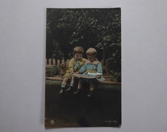Postcard of seated children. RPH. 1906. Two little boys and a small dog. Postmarked 1-cent Canadian stamp, Edward VII. Edwardian postcard.