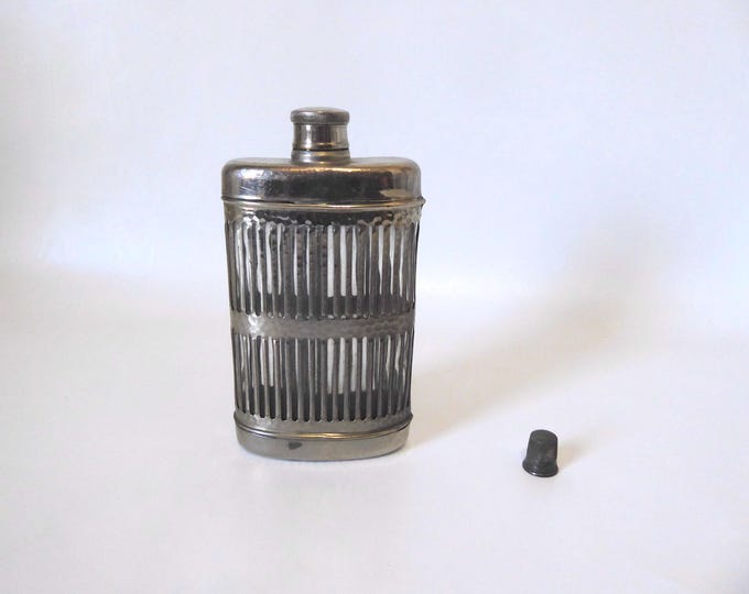 Openwork hammered metal and glass alcohol flask. 1930. Art Deco alcohol flask.