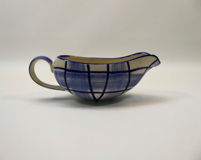 Ceramic gravy boat with stylized blue and white checkered pattern. Year 50.