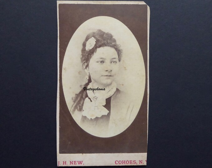 Sepia photo Young woman Victorian era. Visit card. Crop. Hairdressing 1880. J.H.New. Cohoes N.Y. Portrait.