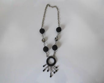 Gold-tone metal chain necklace with crocheted fabric ball and ring. 1980.