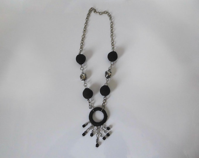 Gold-tone metal chain necklace with crocheted fabric ball and ring. 1980.