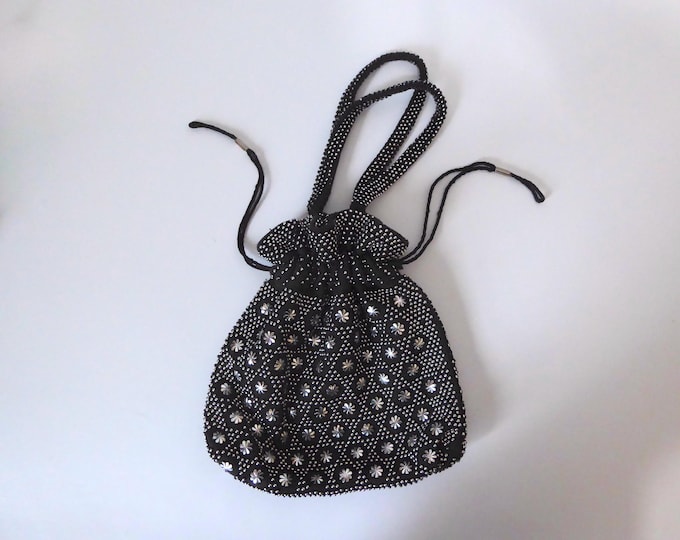Black fabric drawstring bag with silver bead and flower detail. Stein. Made in Hong Kong. 1980s.