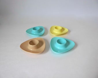 Four molded plastic egg cups in pastel colors. 1970. Mid-century kitchen. Vintage breakfast.