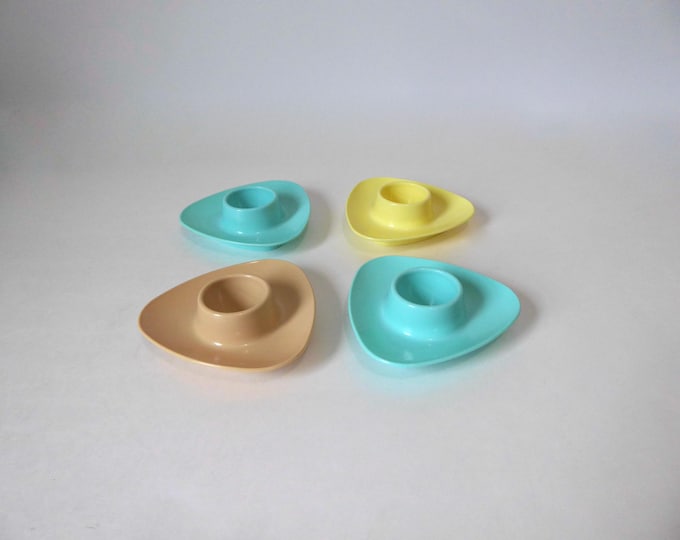 Four molded plastic egg cups in pastel colors. 1970. Mid-century kitchen. Vintage breakfast.