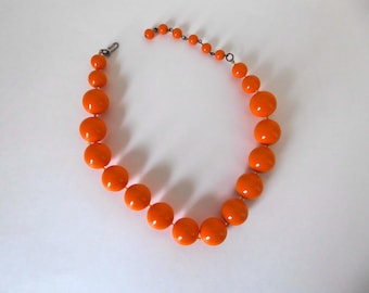 Orange plastic bead choker necklace. 1960