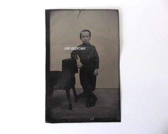 Ferrotype of a young boy standing. Victorian era. 1870. Metal photograph.