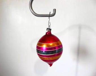 Vintage blown glass Christmas ball in red, blue, pink, and gold. 1950s. Christmas decoration. Vintage Christmas tree.