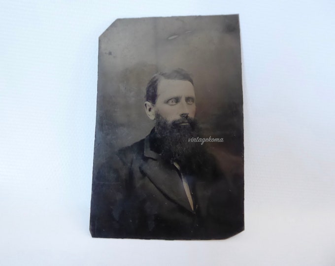Victorian era ferrotype man with beard. 1870. Metal photograph.