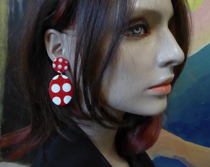 Red oval earring with white polka dots. Red and white lucite. 1960.