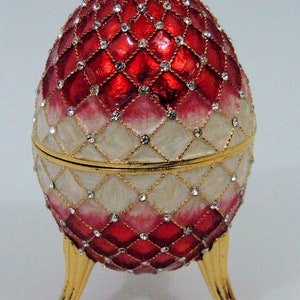Russian Replica Red/white enameled Faberge egg featuring netting/gems, opens to a white enameled inside.