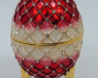 Russian Replica Red/white enameled Faberge egg featuring netting/gems, opens to a white enameled inside.