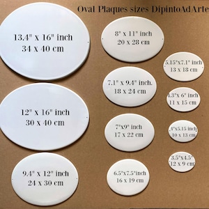 May include: A set of ten white oval ceramic plaques of different sizes. The plaques are blank and have measurements in inches and centimeters printed on them. The plaques are arranged in two rows on a brown surface. The text "Oval Plaques sizes DipintoAdArte" is printed at the top of the image.