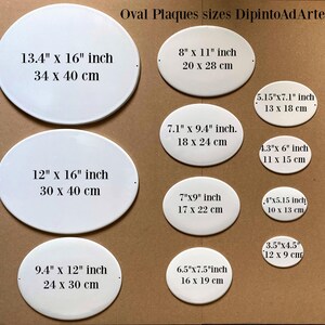 May include: A set of ten white oval ceramic plaques of different sizes. The plaques are blank and have measurements in inches and centimeters printed on them. The plaques are arranged in two rows on a brown surface. The text "Oval Plaques sizes DipintoAdArte" is printed at the top of the image.