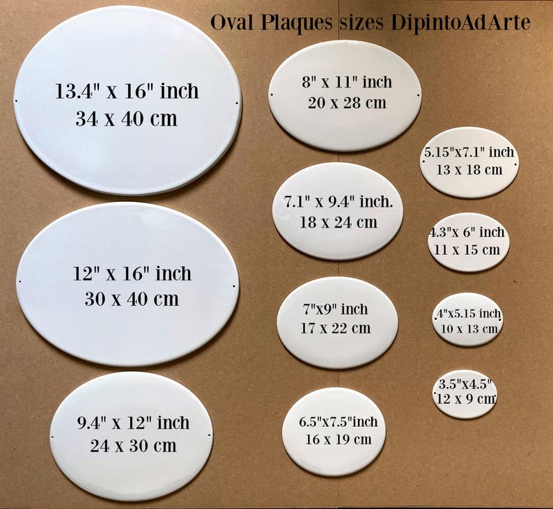 May include: A set of ten white oval ceramic plaques of different sizes. The plaques are blank and have measurements in inches and centimeters printed on them. The plaques are arranged in two rows on a brown surface. The text "Oval Plaques sizes DipintoAdArte" is printed at the top of the image.