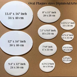 May include: A set of ten white oval ceramic plaques of different sizes. The plaques are blank and have measurements in inches and centimeters printed on them. The plaques are arranged in two rows on a brown surface. The text "Oval Plaques sizes DipintoAdArte" is printed at the top of the image.