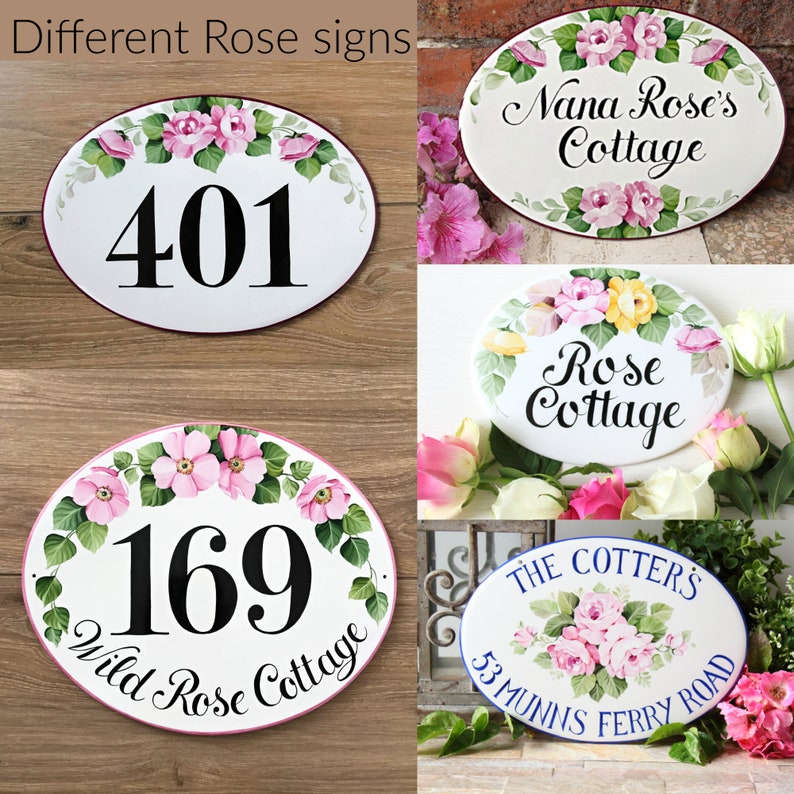 May include: Four oval-shaped ceramic signs with hand-painted rose designs. The signs feature house numbers, names, and addresses. The signs are white with pink, yellow, and green floral accents.