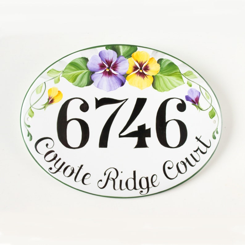 Oval  ceramic address sign hand painted with yellow and purple Pansies, personalized with house number painted in center and the name street curved on bottom