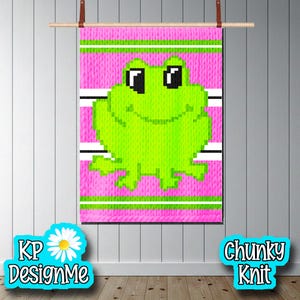 May include: A chunky knit wall hanging featuring a pixelated green frog on a pink background with white and green stripes. The text "KP DesignMe" and "Chunky Knit" are displayed on the bottom. The wall hanging is suspended from a wooden rod.
