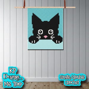 May include: A square crochet wall hanging featuring a pixelated black cat silhouette against a light blue background. The cat has large white eyes, a small pink nose, and white whiskers. The text KP Design Me Too and single/double crochet appear.