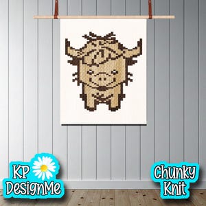 May include: A framed, pixelated image of a Highland cow in shades of brown and tan. The artwork is displayed on a white background and is suspended from a wooden rod with leather straps. The words "KP DesignMe" and "Chunky Knit" are in the image.