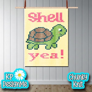 May include: A rectangular wall hanging featuring a pixelated green turtle with a brown shell on a pale yellow background. The text "Shell" appears in pink above the turtle, and "yea!" appears in pink below it. The piece is suspended from a wooden rod.