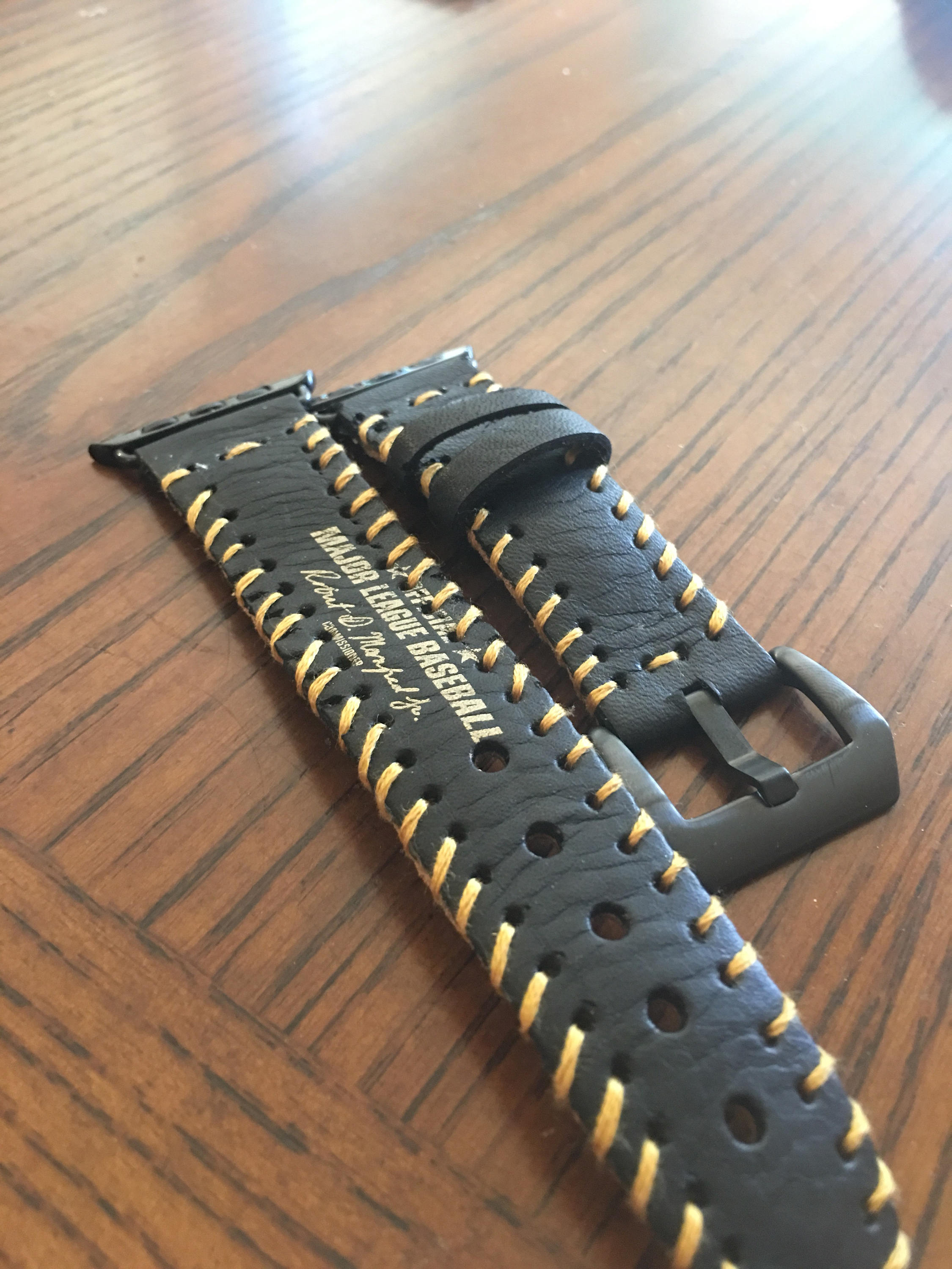 Black/gold Apple Watch strap. Apple watch strap is made from the leat…