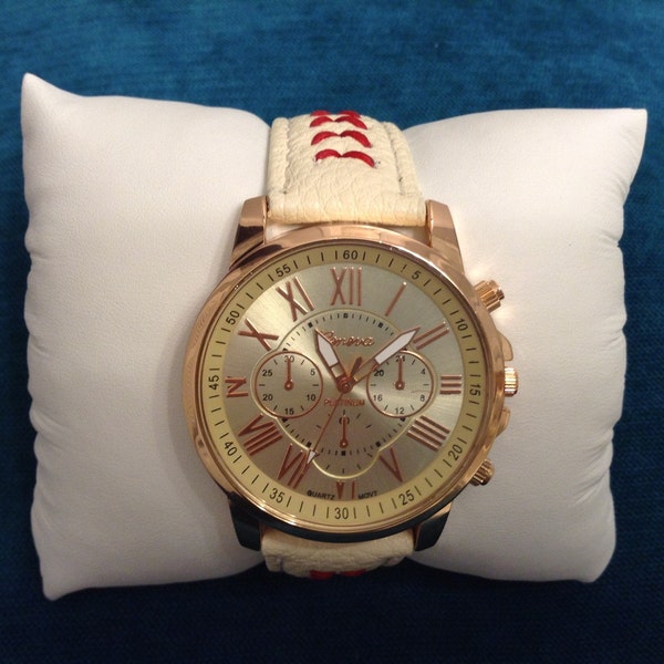 baseball themed watch with red stitching, ivory textured band and copper case.  Beautiful Roman numerals on face.