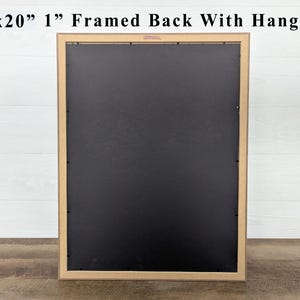May include: A framed artwork's back, measuring 15x20 inches with a 1-inch frame, is displayed. The frame is a light brown color, and the back is black. The text "15x20" 1" Framed Back With Hanger" is visible at the top.