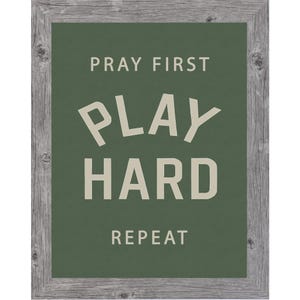 Gray color frame of a Christian sports framed wall art with the phrase Pray First Play Hard Repeat on a green background in a vertical layout