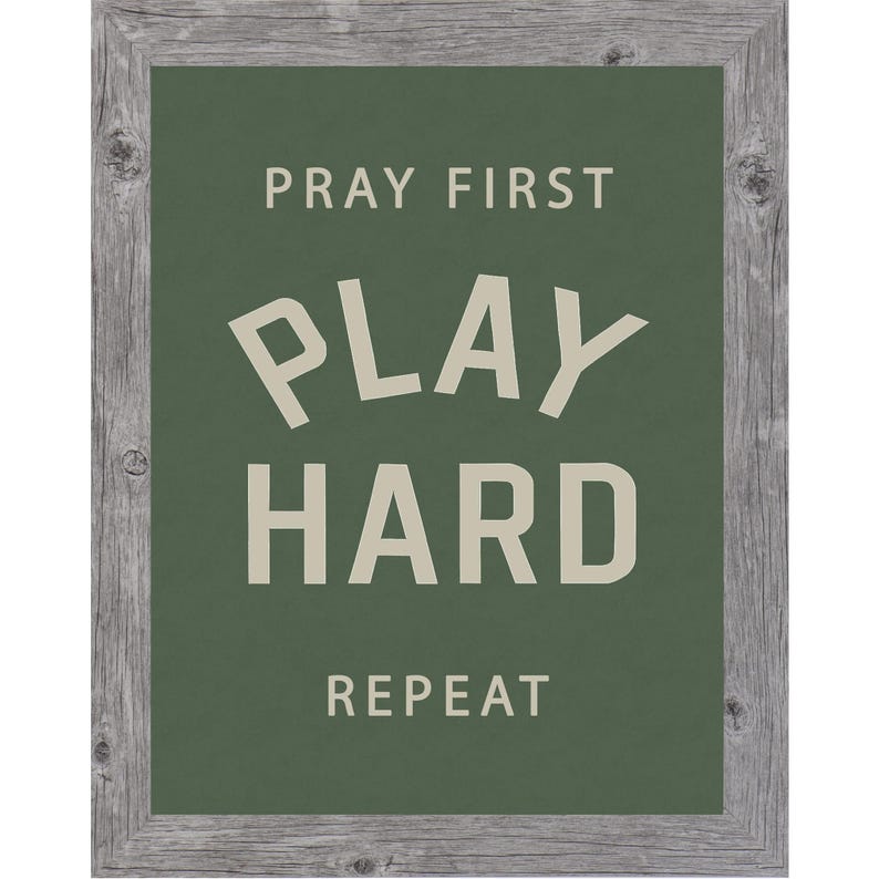 Gray color frame of a Christian sports framed wall art with the phrase Pray First Play Hard Repeat on a green background in a vertical layout