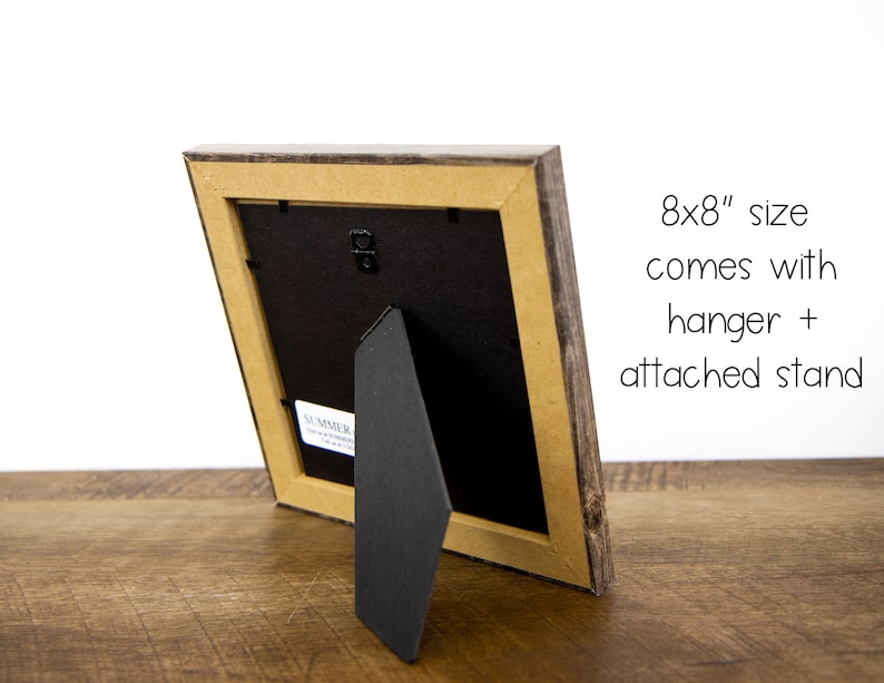 May include: A wooden picture frame with a rustic, weathered appearance. The frame is an 20x20 cm size and includes a hanger and attached stand for versatile display options. The frame has a neutral color palette.