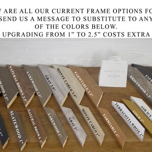 May include: A selection of picture frame samples in various colours and styles, including black, grey, brown, and white. The frames are labelled with names and sizes, with a white shopping bag in the background.