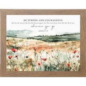 May include: A framed wall art print featuring a watercolor landscape of a wildflower meadow with red poppies and green hills. The text reads: BE STRONG AND COURAGEOUS. Do Not Be Afraid; Do Not Be Discouraged, For The Lord Your God Will Be With You wherever you go JOSHUA 1:9.