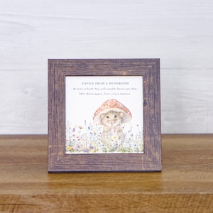 May include: A framed print with a watercolor illustration of a mouse wearing a mushroom cap. The print has the text "ADVICE FROM A MUSHROOM" and the following text: "Be down to Earth. Stay well rounded. Sprout new ideas. Offer Moral support. Grow even in darkness."