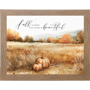May include: A framed watercolor print featuring a fall landscape with pumpkins. The artwork includes the text "Fall is proof that change is beautiful." The scene depicts a field with tall grass, trees with orange and yellow leaves, and a mountain range in the background.