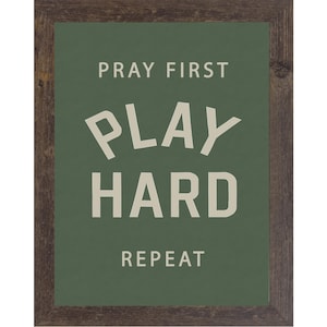 Natural brown color frame of a Christian sports framed wall art with the phrase Pray First Play Hard Repeat on a green background in a vertical layout