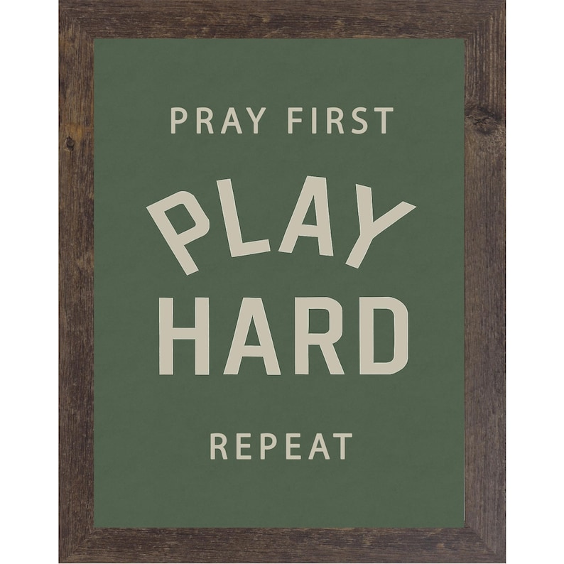 Natural brown color frame of a Christian sports framed wall art with the phrase Pray First Play Hard Repeat on a green background in a vertical layout