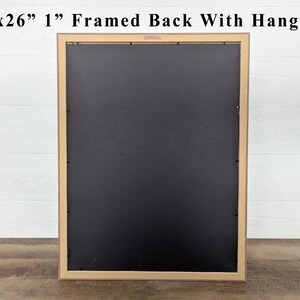May include: A framed artwork's back, measuring 20x26 inches with a 1-inch frame, is shown. The frame is a light brown color, and the back is black. The text "20x26" 1" Framed Back With Hanger" is at the top.