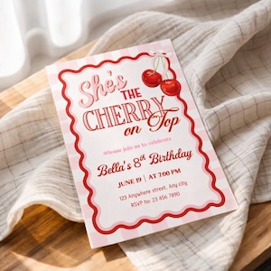 May include: A pink and white invitation card with the text "She's the Cherry on Top" and "Bella's 8th Birthday". The card features a red scalloped border and cherry illustrations. The invitation includes the date, time, and RSVP information.