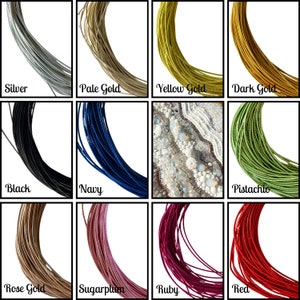 May include: A collection of 12 spools of cord in various colours, including silver, pale gold, yellow gold, dark gold, black, navy, pistachio, rose gold, sugarplum, ruby, and red.