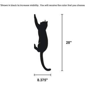 Shows the size of the metal cat decor.
